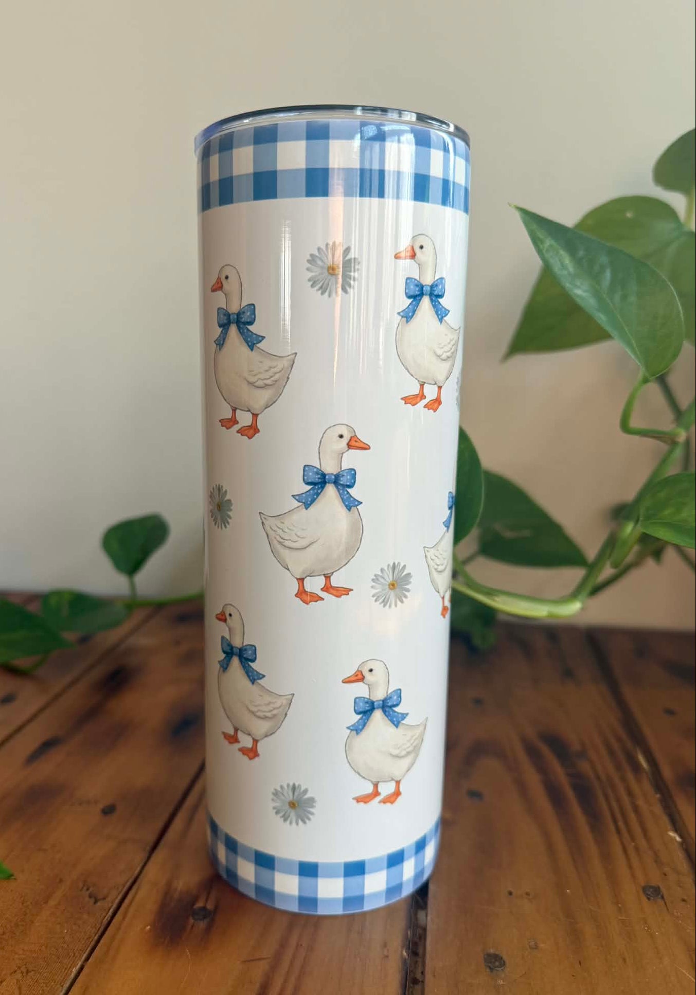 Tumbler with duck design on a wooden surface
