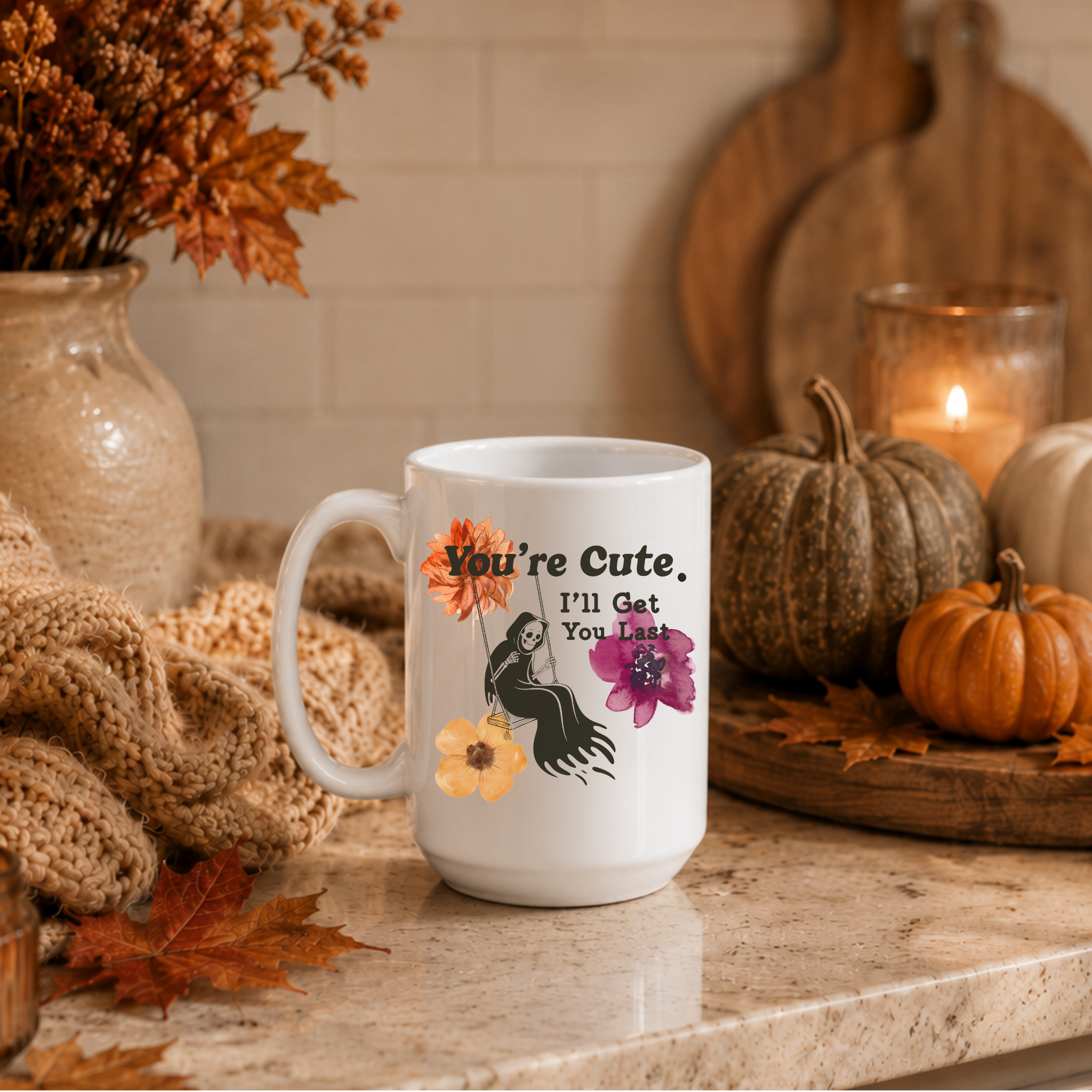 a white mug with a grim reaper swinging set on a countertop decorated for Fall. 